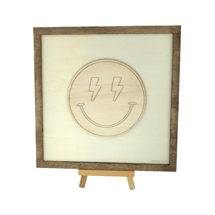 Customizable wall art frame of a lightning smiley in cut and engraved wood front view with easel Woodillusion