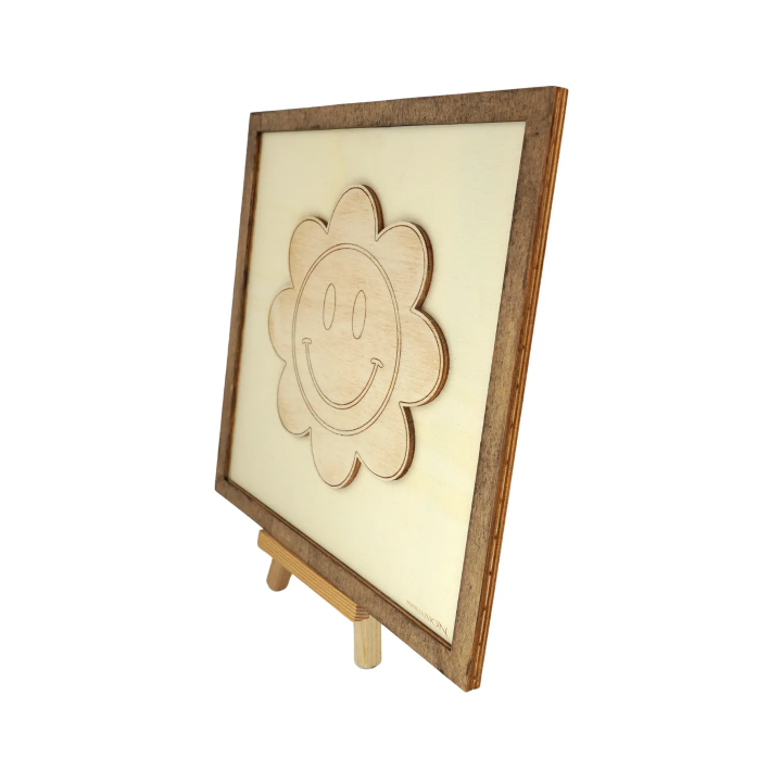 Customizable wall art frame of a flower smiley in cut and engraved wood side view with easel Woodillusion