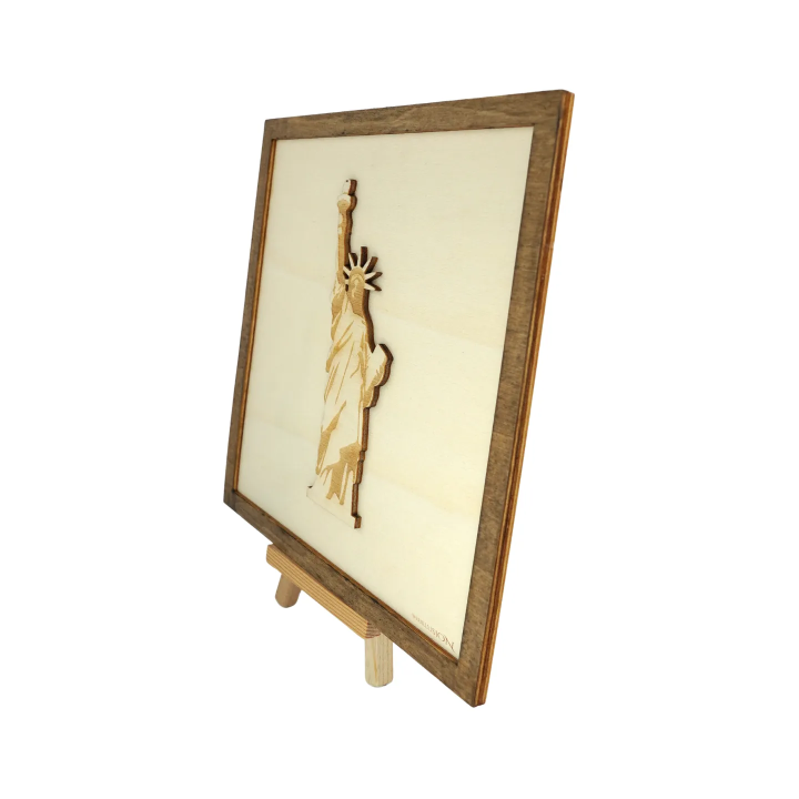 Customizable wall art frame of the Statue of Liberty in cut and engraved wood side view with easel Woodillusion