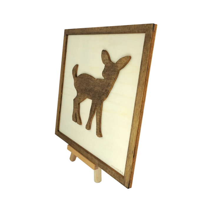 Customizable wall art frame of a fawn in cut and engraved wood front view with easel Woodillusion