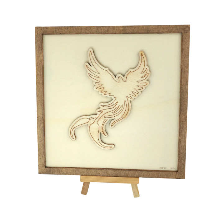 Customizable wall art frame of a phoenix in cut and engraved wood front view with easel Woodillusion