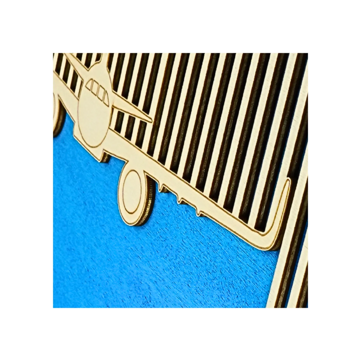 Zoom on a customizable wall art frame of an aeronautical design in cut and engraved wood